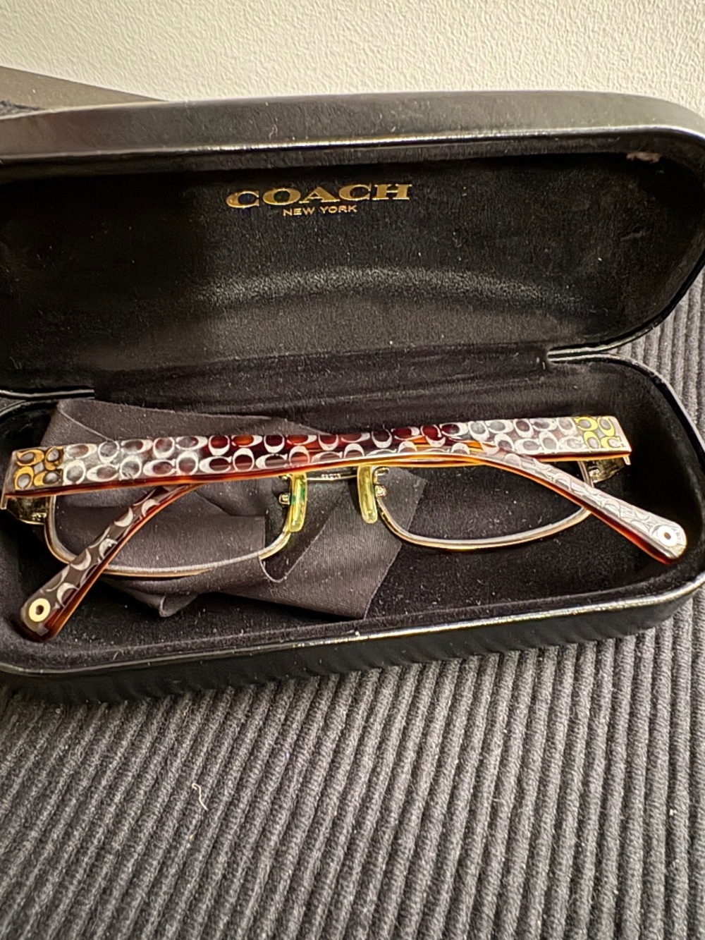 Black Coach eyeglass case and signature metal glasses.